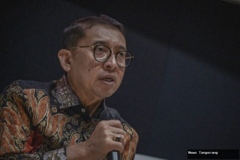 Fadli Zon berbicara dengan mikrofon, mengenakan batik, sorotan pada wajah.