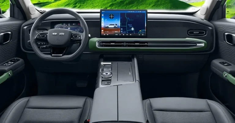 Interior mobil modern dengan layar infotainment besar, setir multifungsi, dashboard digital, dan aksen hijau.