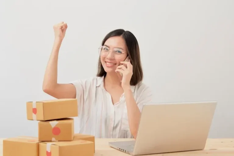 a woman sitting in front of a laptop computer