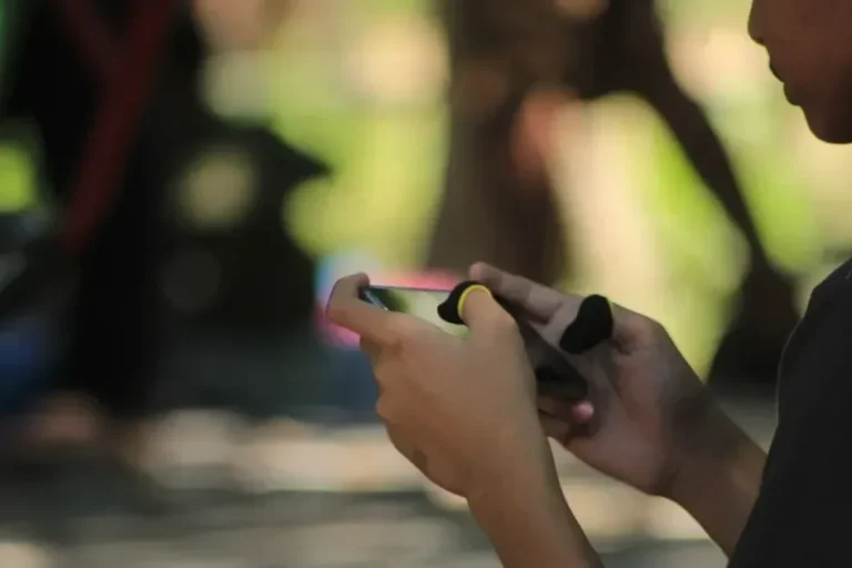 A woman is looking at her cell phone